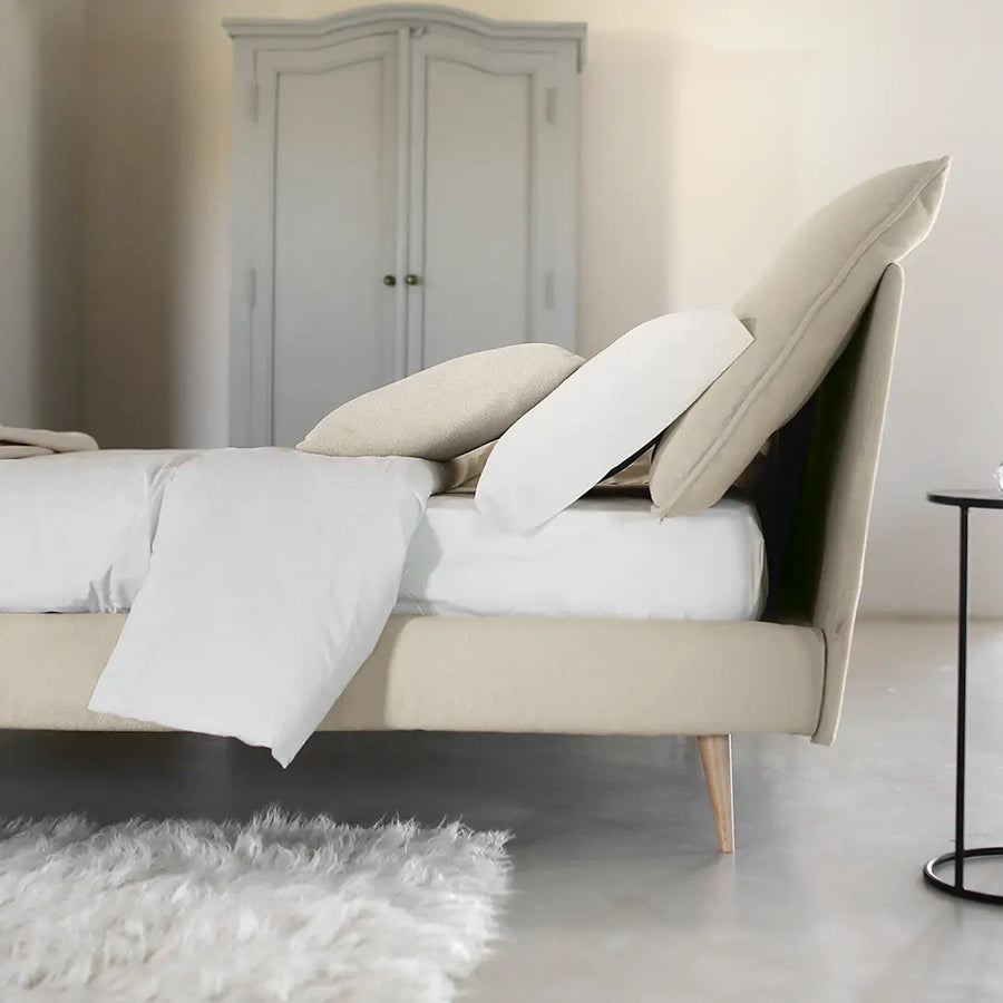 Slumberstore Pillow Storage Bed, side view of the adjustable pillows in the headboard, shown here in a beautiful beige base and headboard with natural wood feet | Spaceman space saving furniture, Singapore.