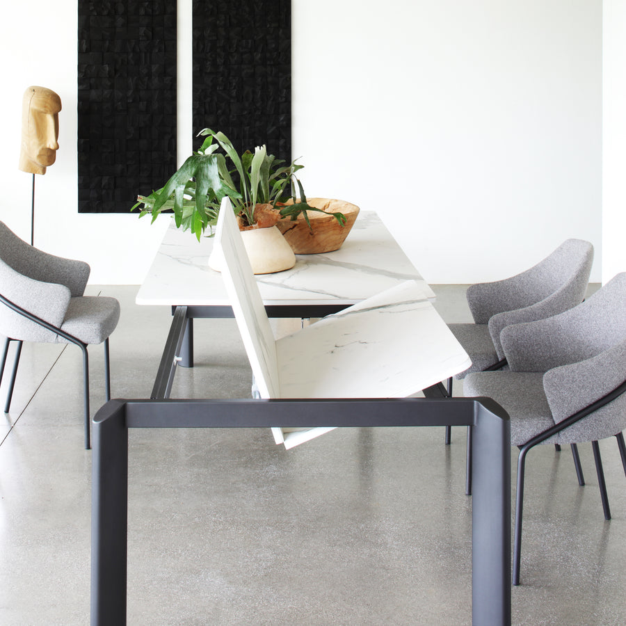 Orb extending dining table - Space sacing dining tables - Spaceman Singapore - Featuring Orb with matte ceramic top - Concealed extension panel unfolding like a book. 